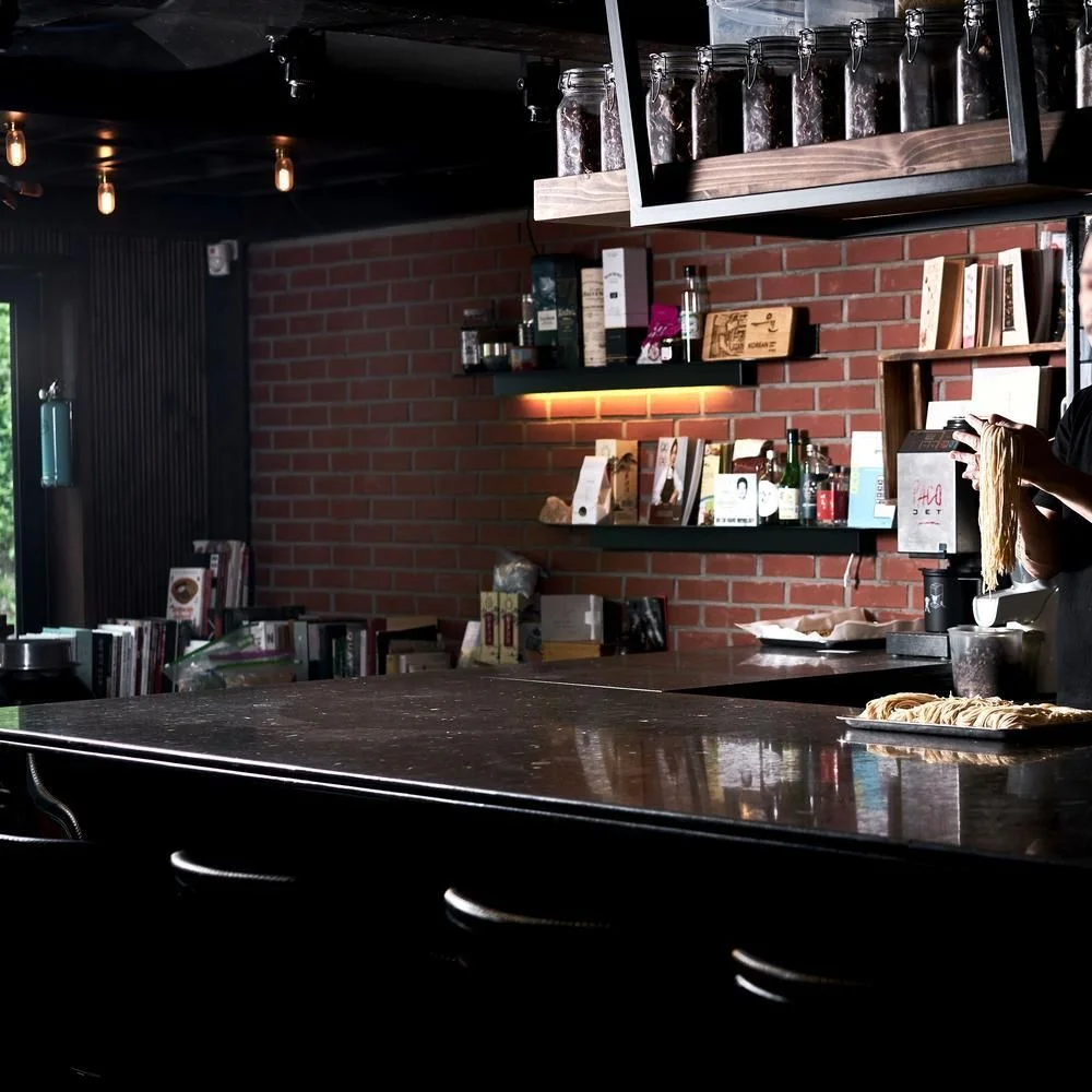 YUN: dark wood bar and shelves
