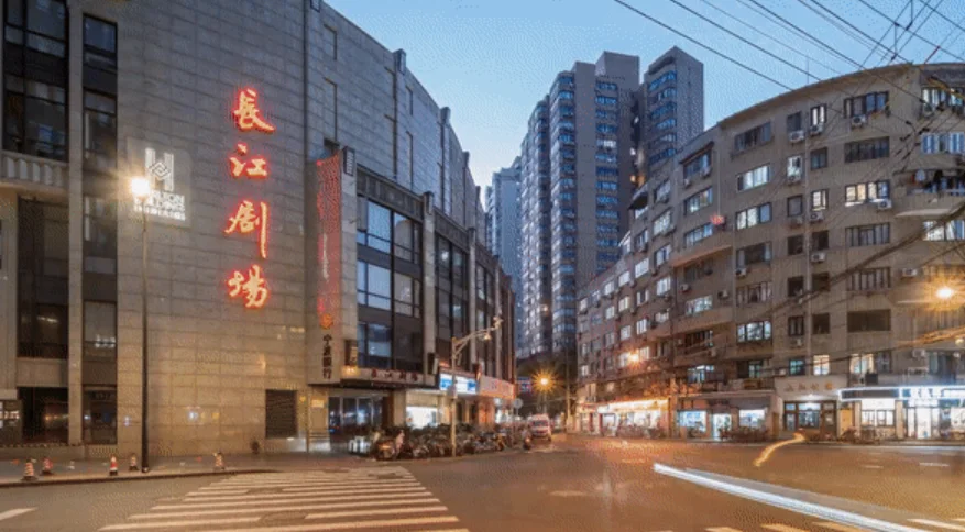 Changjiang Theatre: the theatre's illuminated name on the city street at dusk