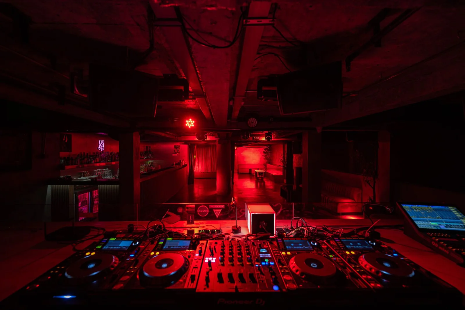 The red-lit DJ booth and bar at Exit in Shanghai