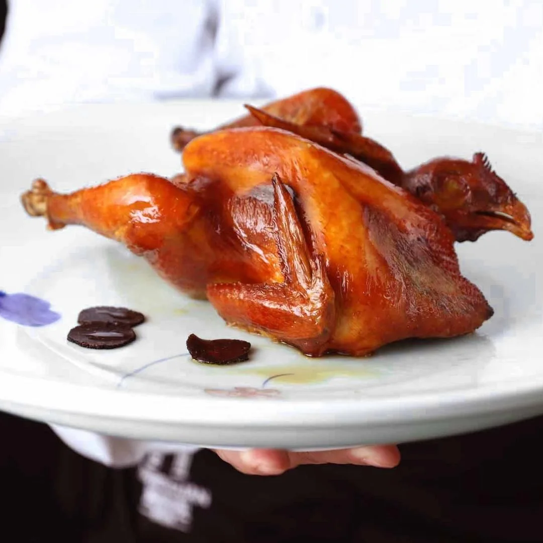 Hai Wei Guan (Jingan): a whole roasted bird presented on a white platter, pictured by the listed source