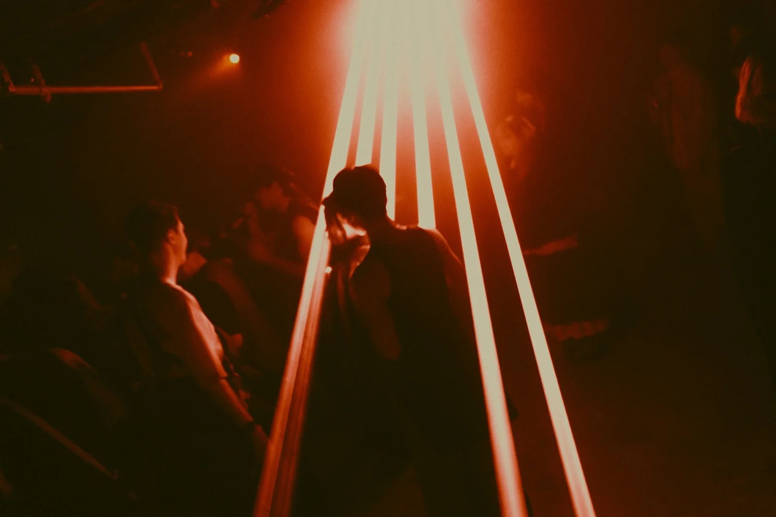 Reactor Shanghai: dancers silhouetted beneath red beams of club lighting