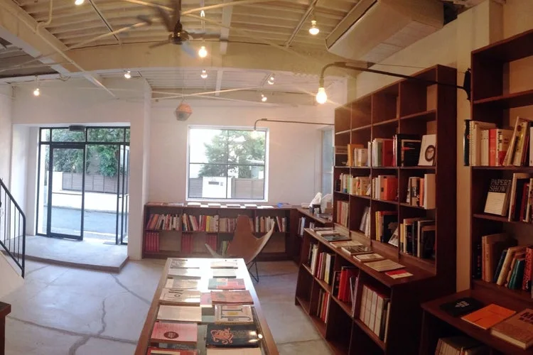 Book And Sons: wooden shelves and display tables in the light-filled bookshop