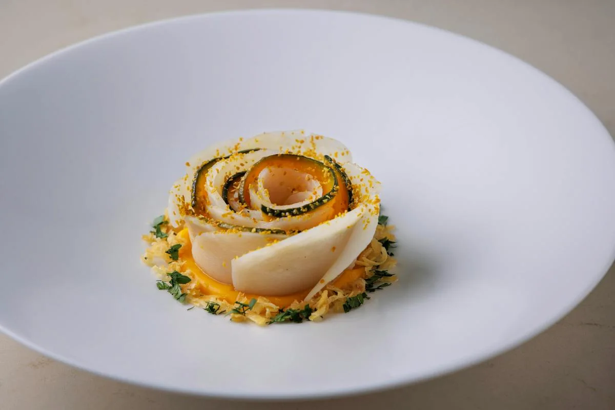 est: a finely plated dish on a white plate, shown on its official website