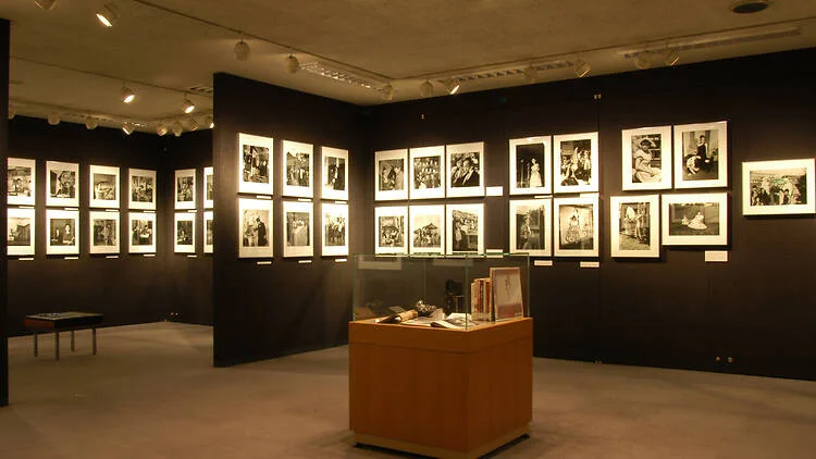 JCII Photo Salon: black-and-white photographs displayed against the salon's dark walls