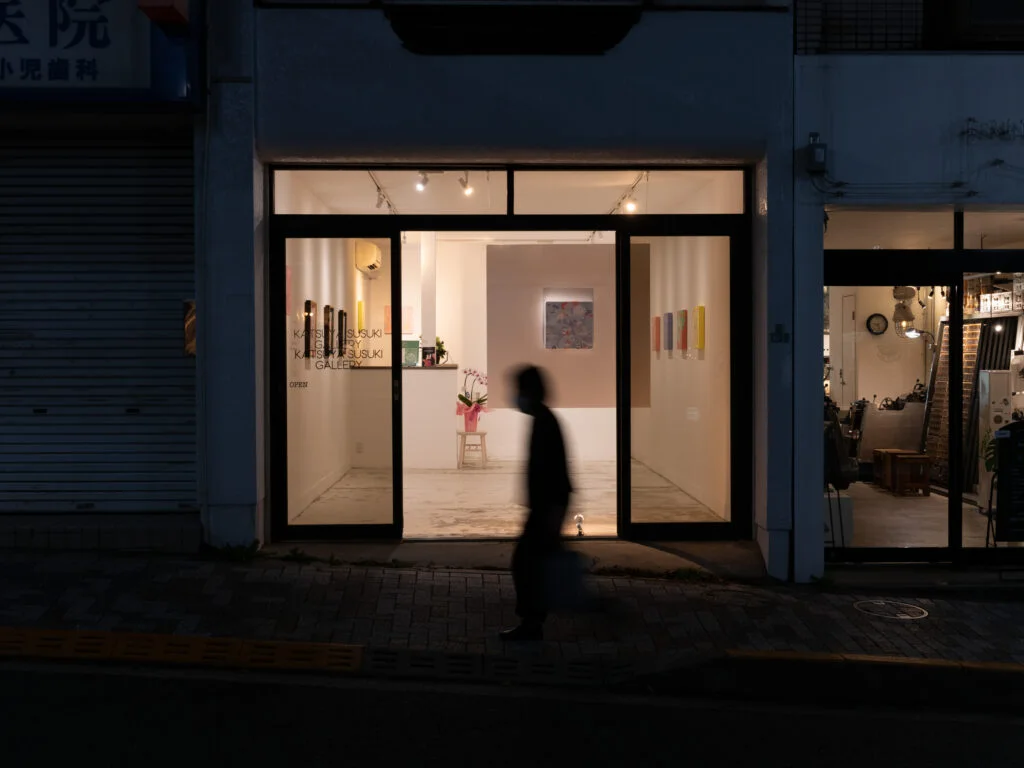 The gallery entrance illuminated from the street at Katsuya Susuki Gallery
