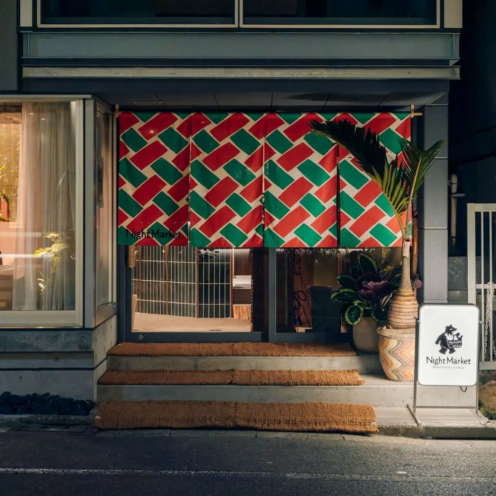 A small restaurant entrance decorated with a woven red-and-green pattern at Night Market