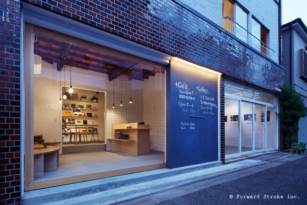 The gallery shopfront illuminated at dusk at Ogu Mag