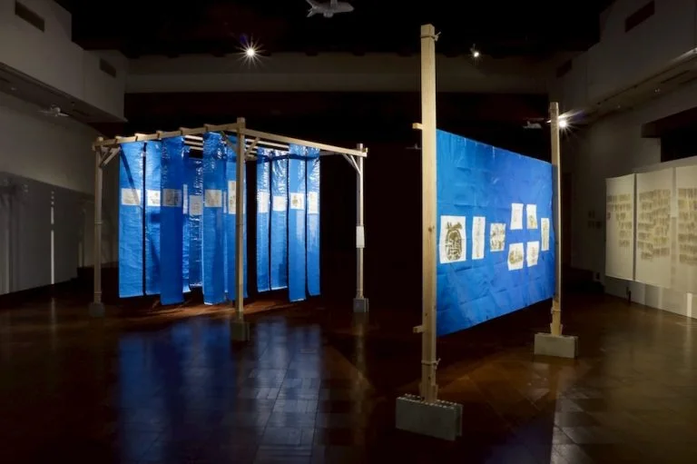 Up & Coming: installation with blue fabric panels in the exhibition space