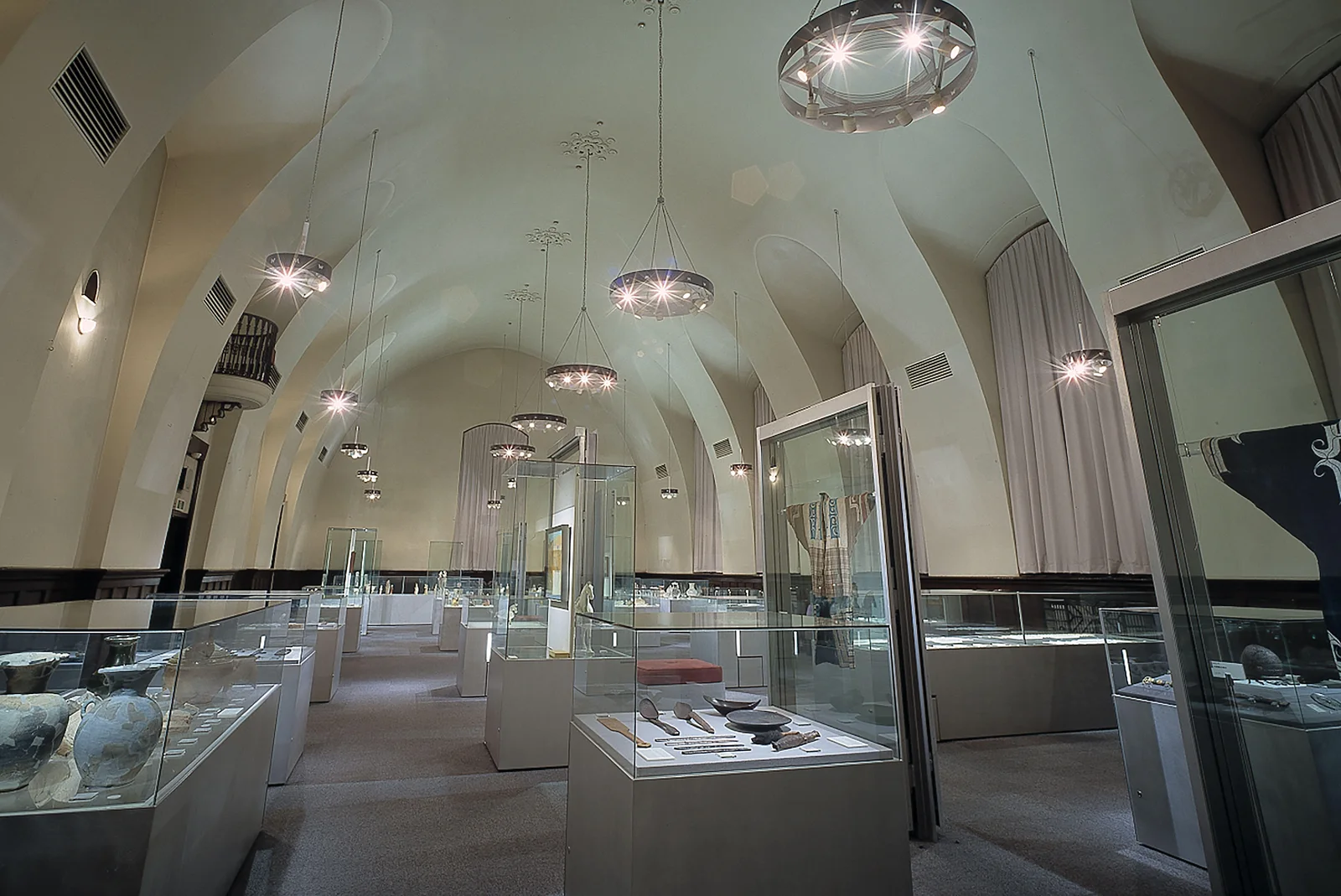 Waseda University Aizu Museum: glass display cases beneath the museum's arched ceiling
