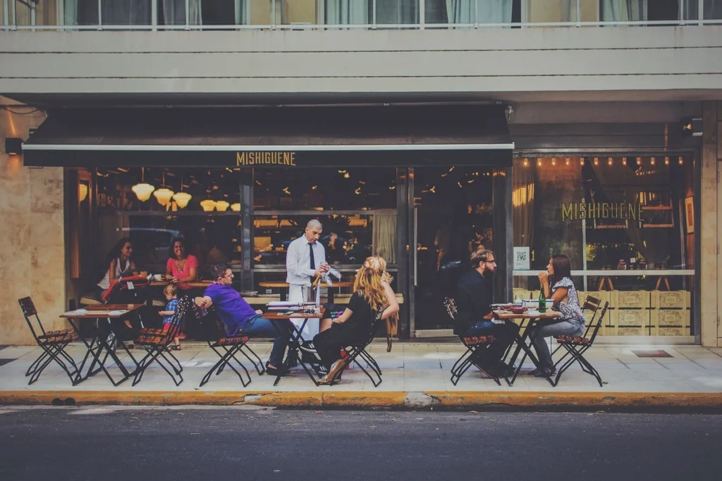 Diners outside Mishiguene beneath its black awning in Buenos Aires; archival photograph, date unknown